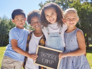 Kids holding a summer camp sign